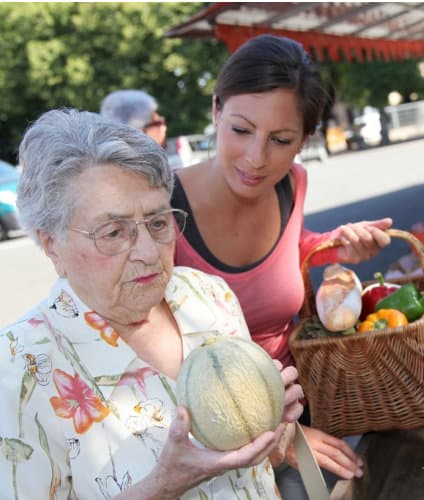 caregiver assisting senior on grocery