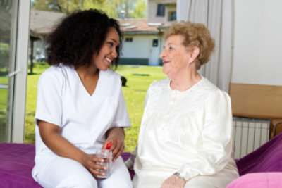 female caregiver talking to a senior woman