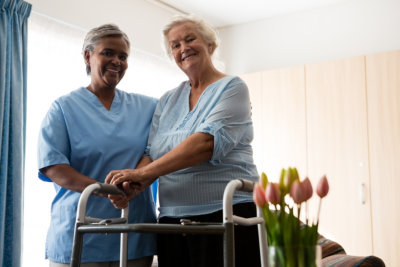 caretaker and senior woman smiling together